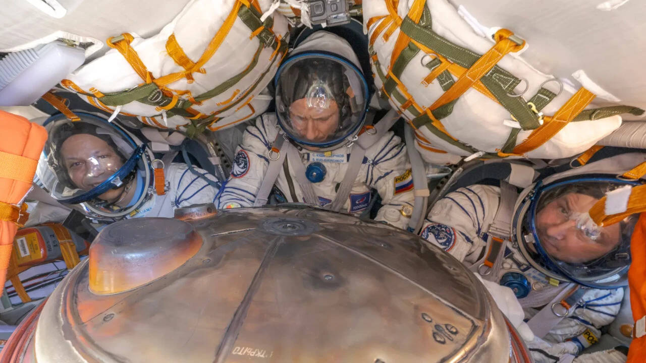 A US-Russian space crew lands safely in Kazakhstan after an 8-month stint on the ISS